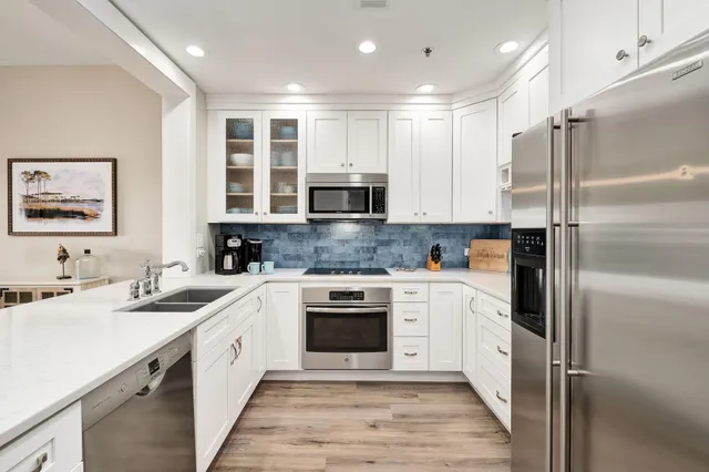 a kitchen with a sink cabinets and stainless steel appliances