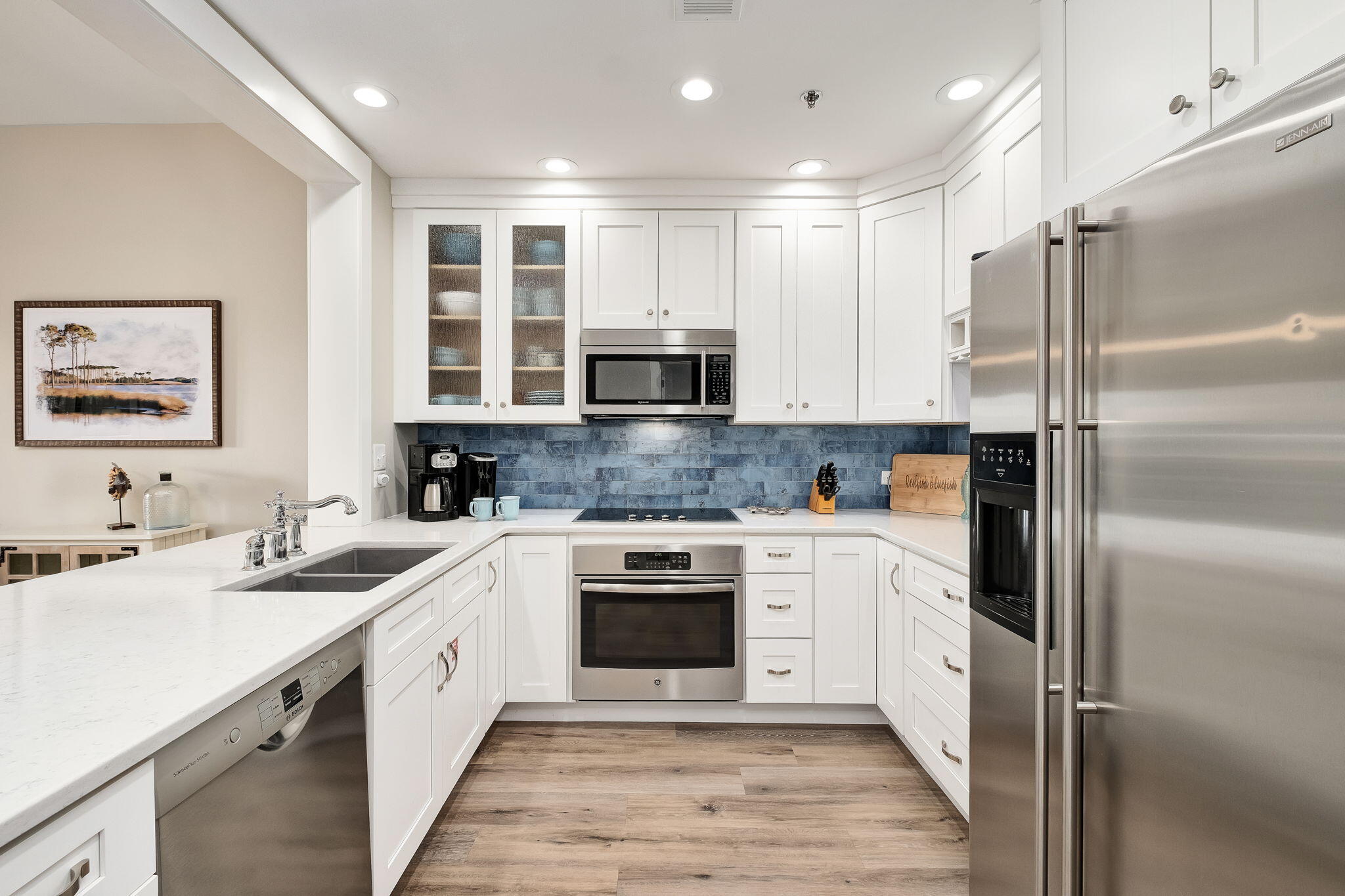 a kitchen with a sink cabinets and stainless steel appliances