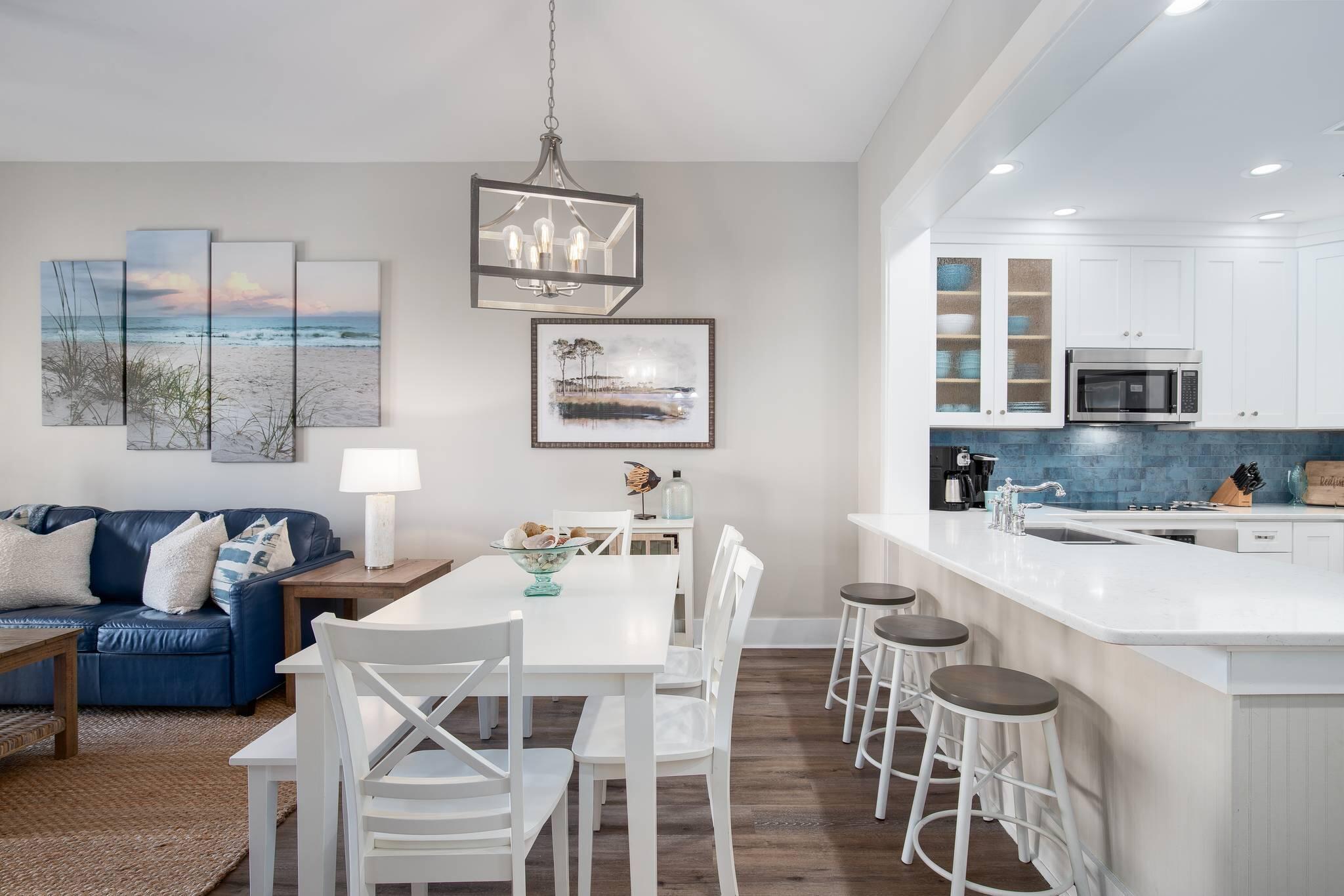 2050 West County Highway 30A, Unit M1310 Santa Rosa Beach, FL 32459 - Photo 11 of 63 a view of a dining room with furniture a couch and wooden floor