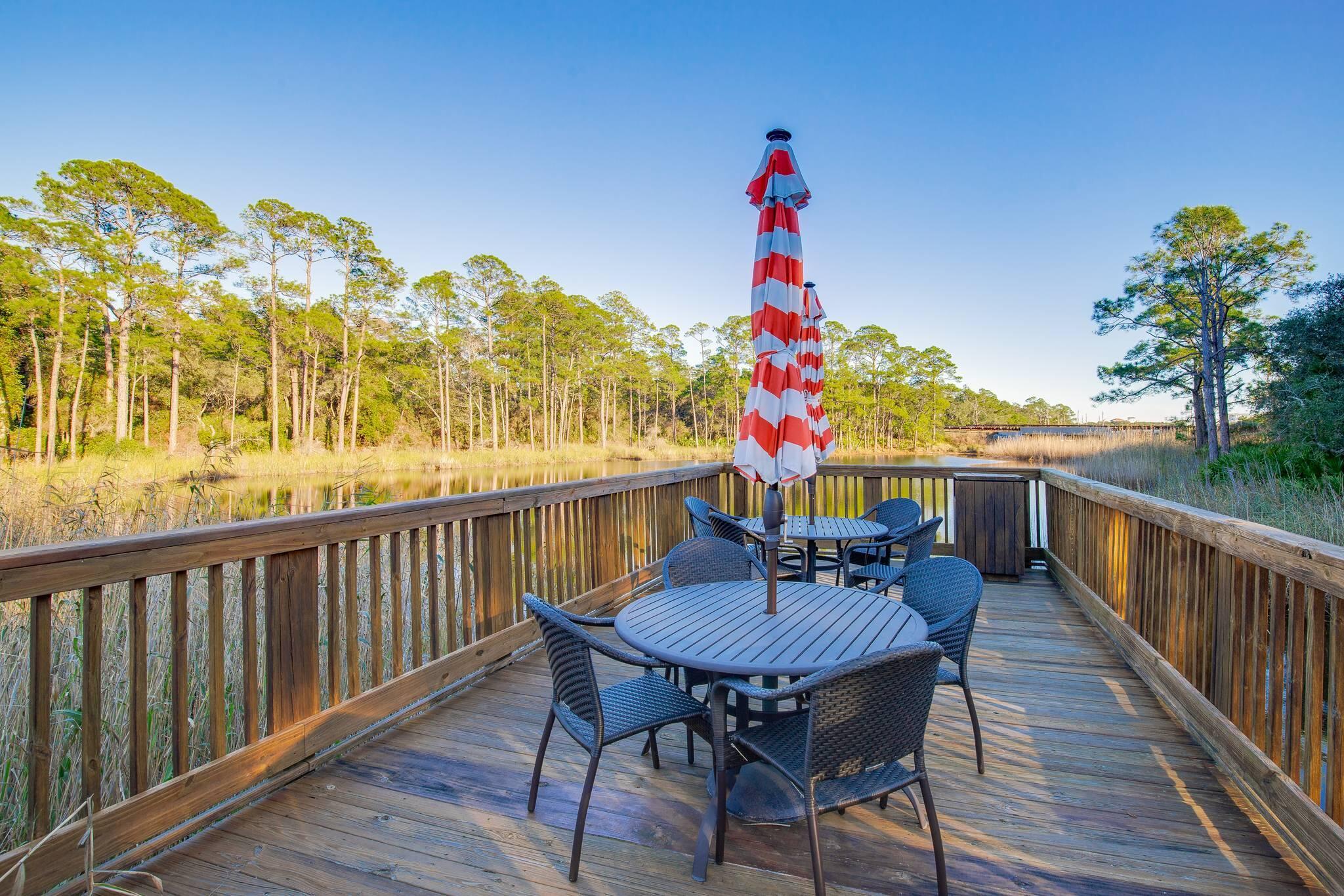 2050 West County Highway 30A, Unit M1310 Santa Rosa Beach, FL 32459 - Photo 44 of 63 a view of a chairs and table on the deck and a patio