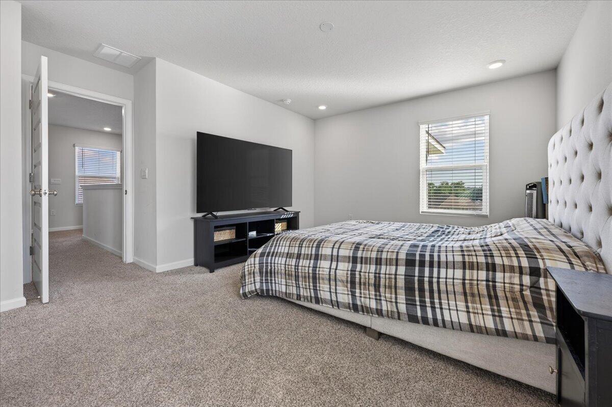 2808 Tallgrass Court Crestview, FL 32536 - Photo 25 of 49 a bedroom with a bed and a flat screen tv