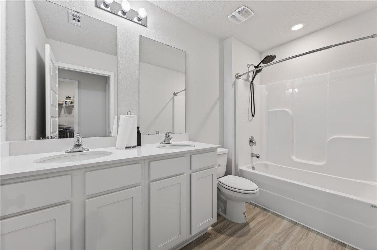 2808 Tallgrass Court Crestview, FL 32536 - Photo 31 of 49 a bathroom with a double vanity sink toilet mirror and shower