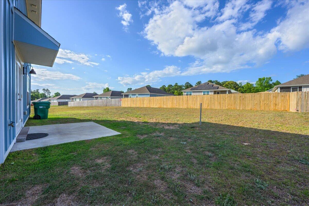 2808 Tallgrass Court Crestview, FL 32536 - Photo 41 of 49 a view of a lake with houses in the back