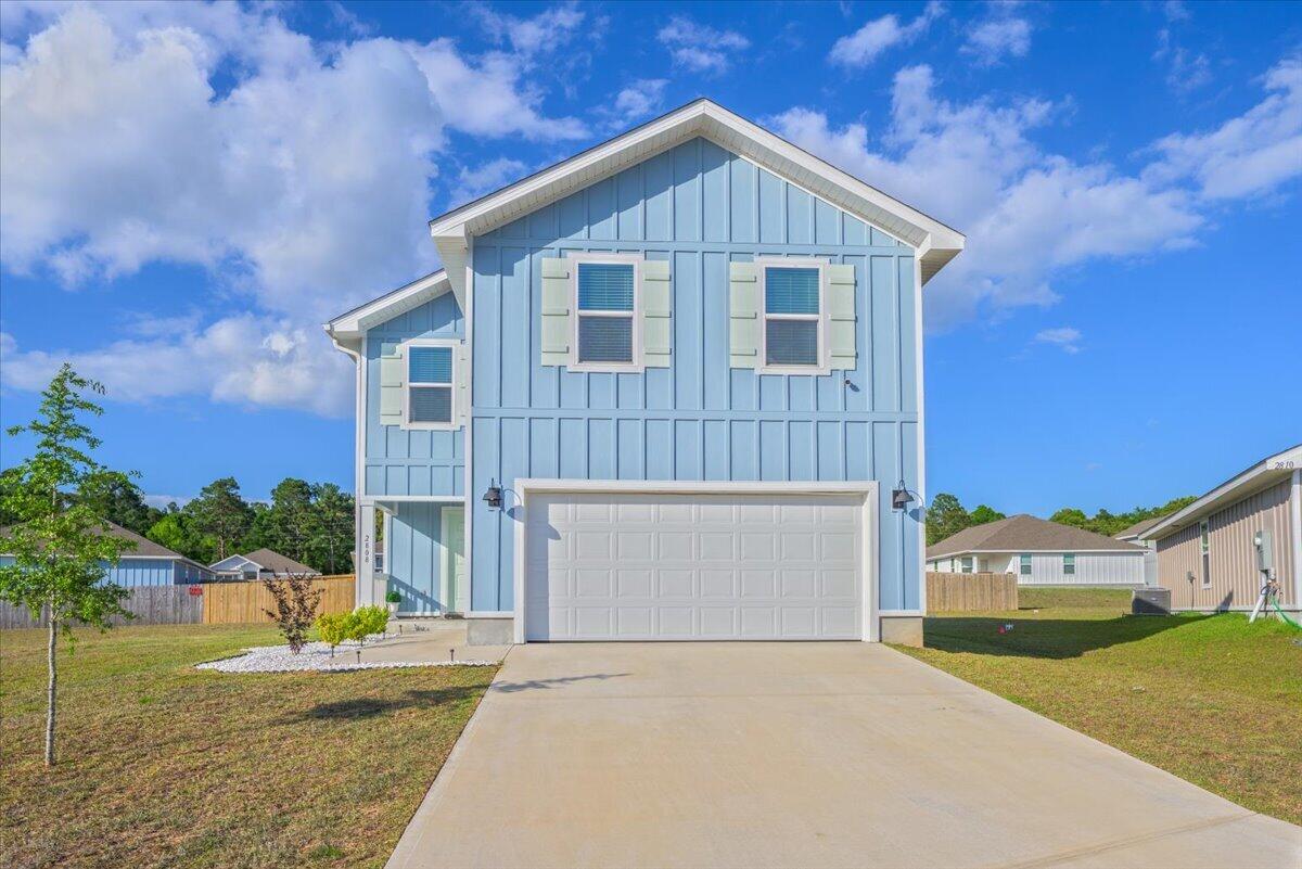 2808 Tallgrass Court Crestview, FL 32536 - Photo 44 of 49 a front view of a house with a yard and garage