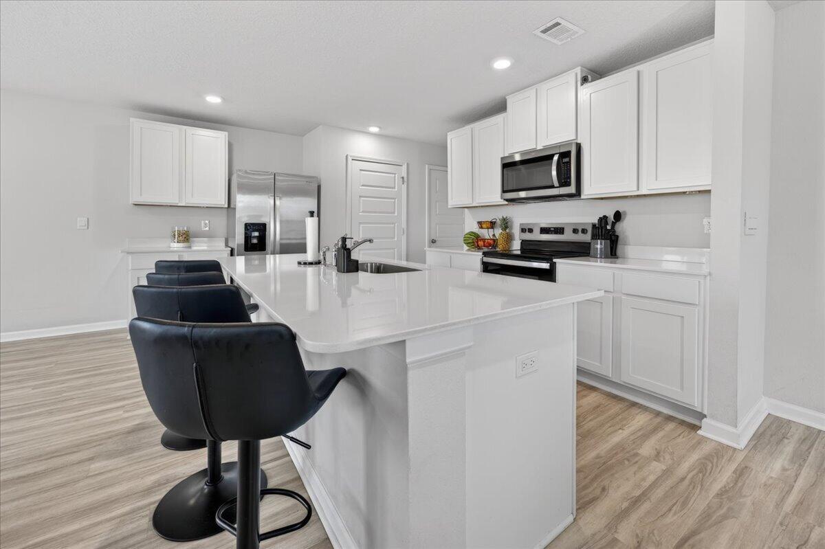 2808 Tallgrass Court Crestview, FL 32536 - Photo 6 of 49 a kitchen with stainless steel appliances a stove a sink a refrigerator and cabinets