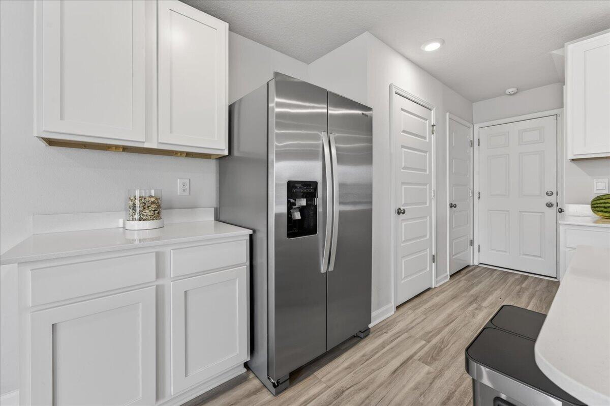 2808 Tallgrass Court Crestview, FL 32536 - Photo 8 of 49 a kitchen with stainless steel appliances a refrigerator and cabinets