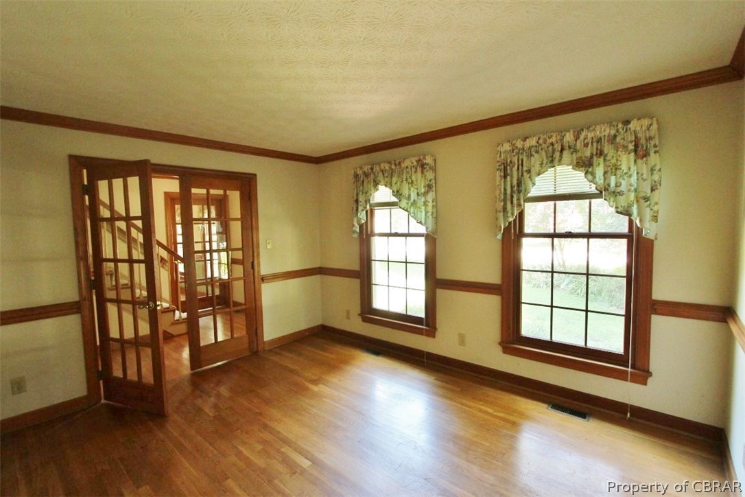 308 Tides Run Yorktown, VA 23692 - Photo 5 of 34 a view of an empty room with wooden floor and a window