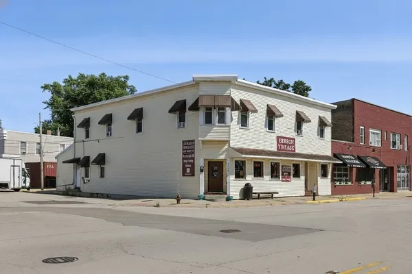 a front view of a building with a road