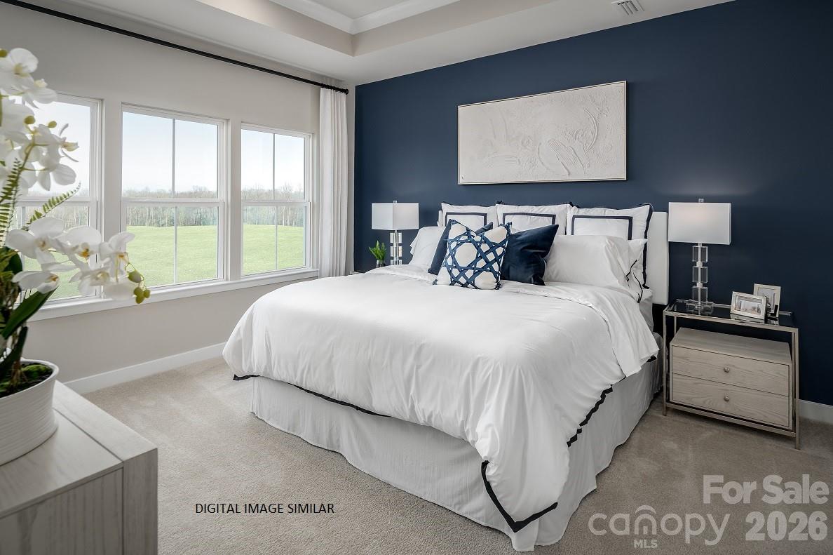 2287 Flicker Road, Unit 1050A Indian Land, SC 29707 - Photo 6 of 13 a large bed sitting in a bedroom next to a window