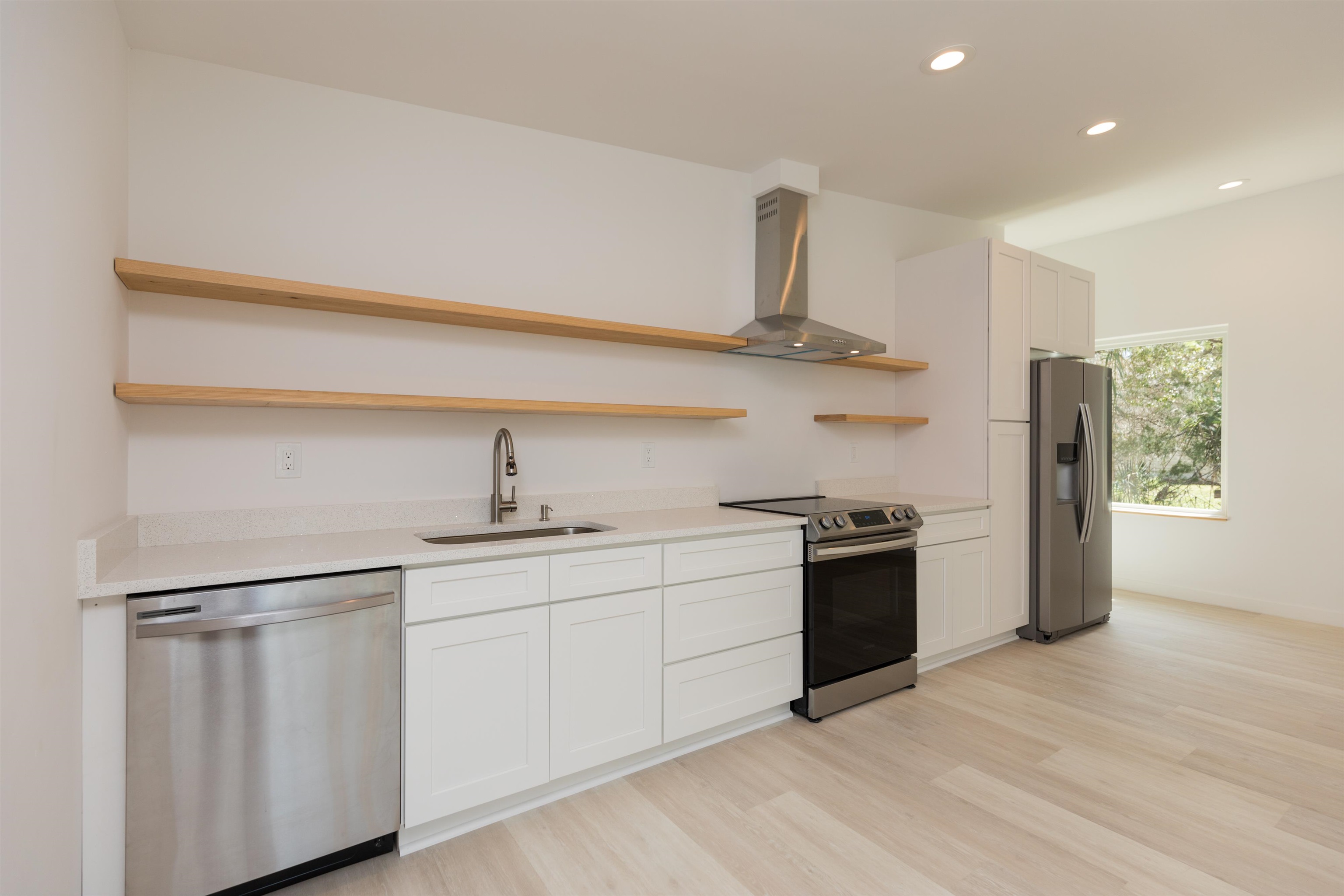 561 Live Oak Street St. Augustine, FL 32084 - Photo 12 of 30 a kitchen with stainless steel appliances granite countertop a sink and a stove top oven