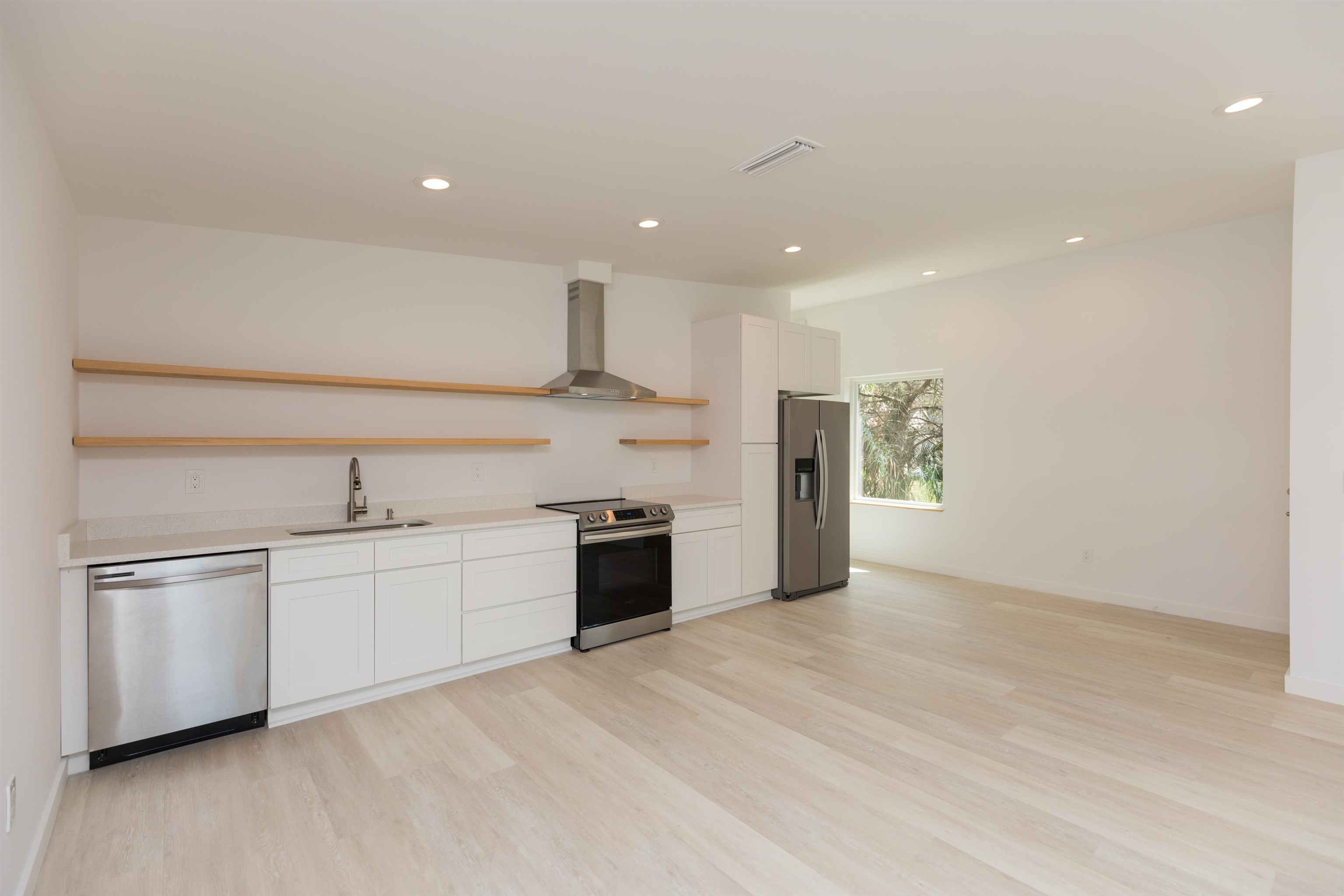 561 Live Oak Street St. Augustine, FL 32084 - Photo 13 of 30 a large kitchen with a stove a sink and a refrigerator