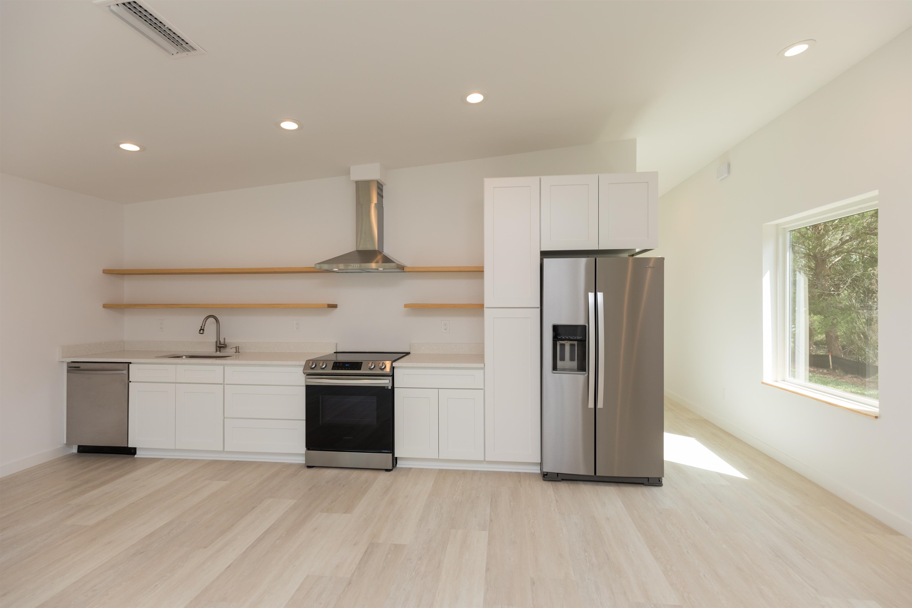 561 Live Oak Street St. Augustine, FL 32084 - Photo 14 of 30 a kitchen with stainless steel appliances a refrigerator sink and stove