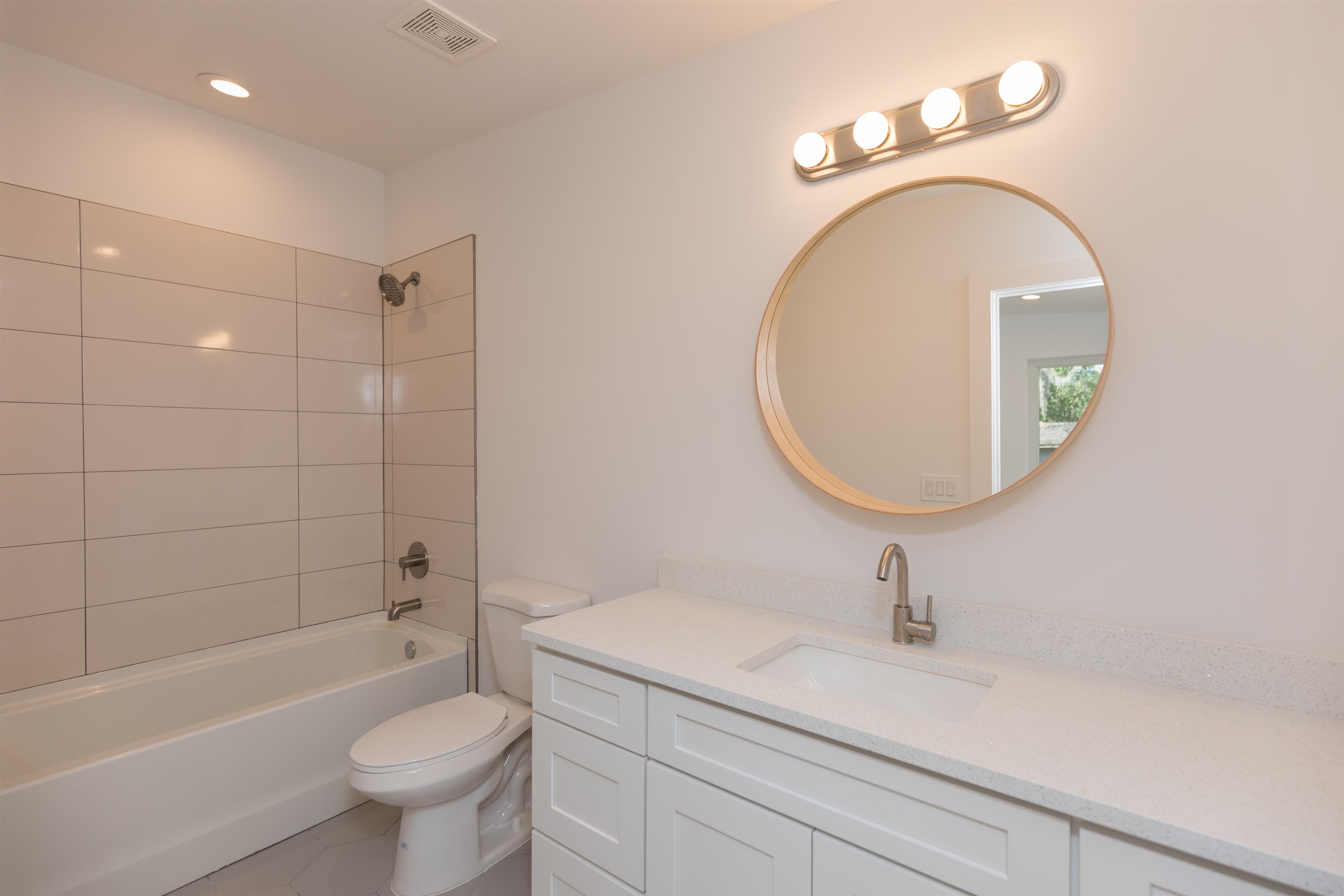 561 Live Oak Street St. Augustine, FL 32084 - Photo 24 of 30 a bathroom with a sink a toilet and a mirror