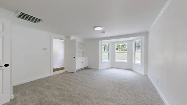 a view of an empty room with a window