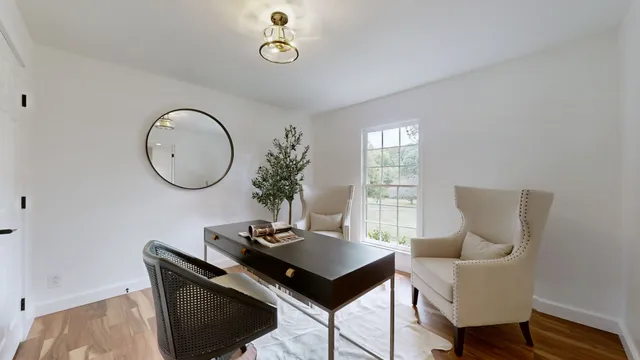 a living room with furniture a mirror and a window