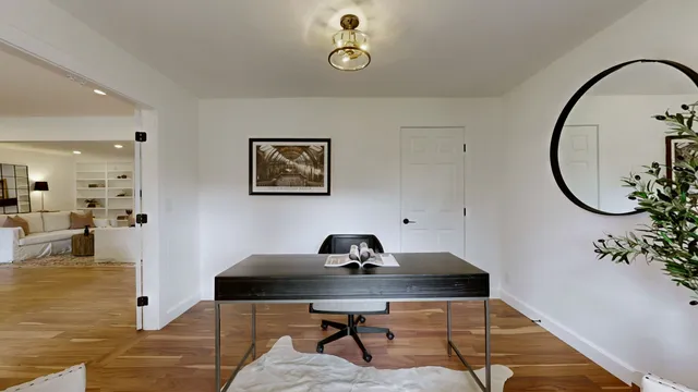 a workspace with furniture and mirror