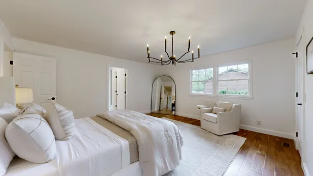 a bedroom with bed and window