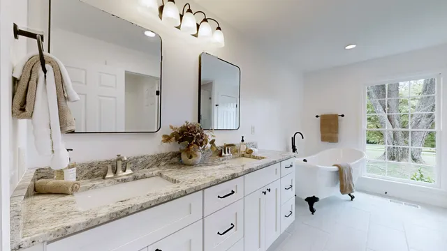 a bathroom with double vanity sinks a vanity and a mirror