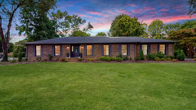 a front view of house with yard and green space