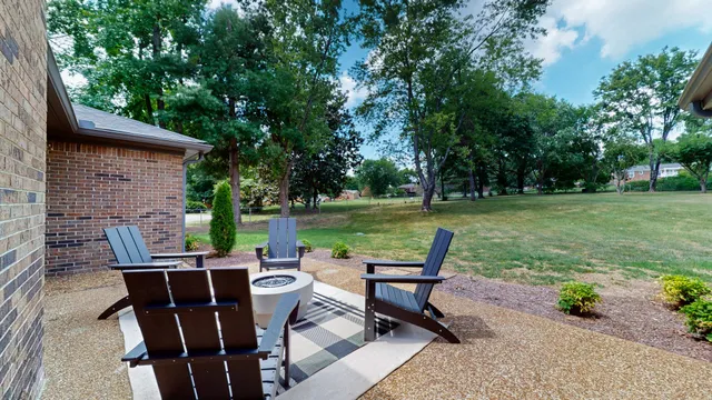a view of a chairs and table in backyard of the house