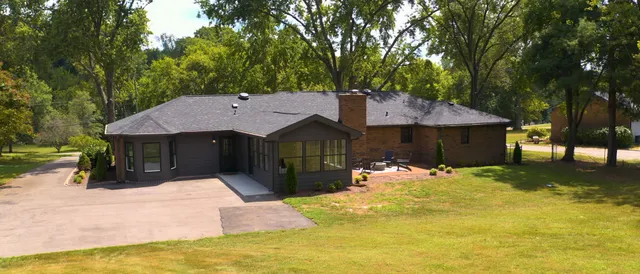 a front view of a house with a yard outdoor seating and yard