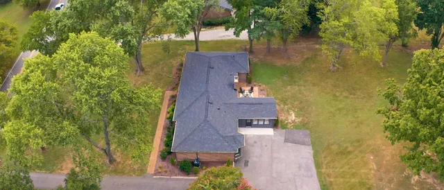 an aerial view of a house with a yard