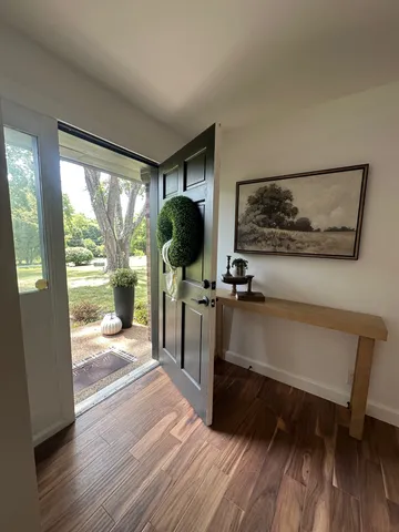 a view of a living room and dining room with wooden floor