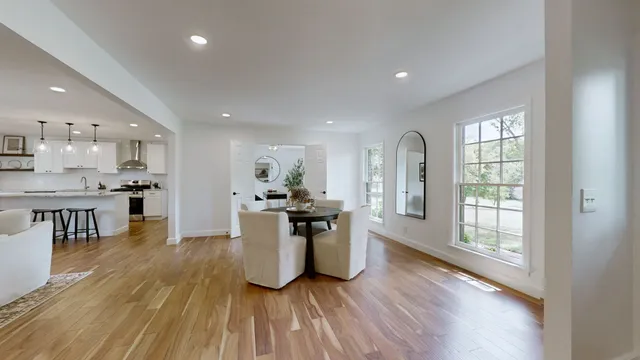 a view of a kitchen with kitchen island and stainless steel appliances