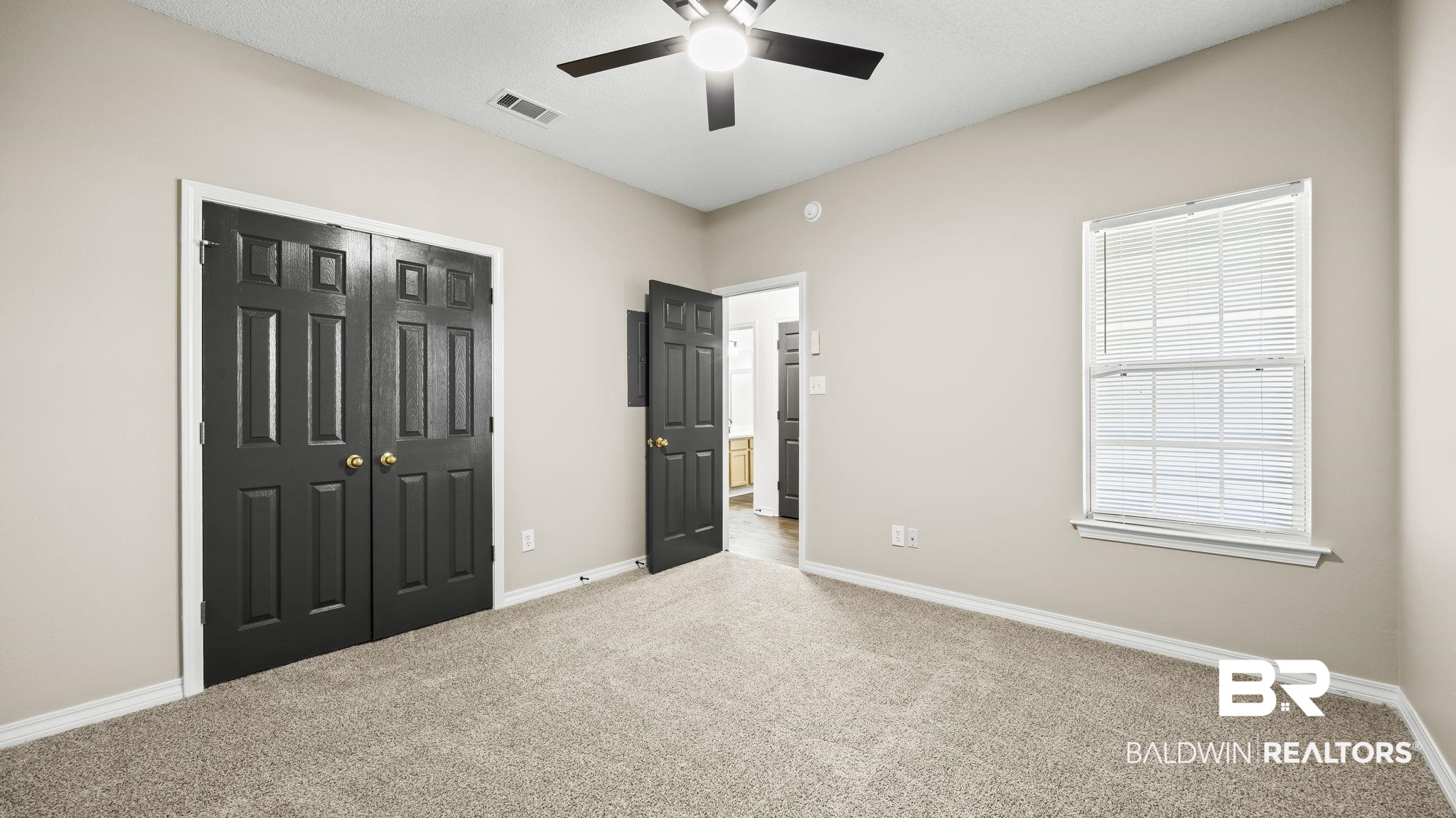 2651 South Juniper Street, Unit 705 Foley, AL 36535 - Photo 13 of 37 Neutral-toned walls complement the carpeted flooring