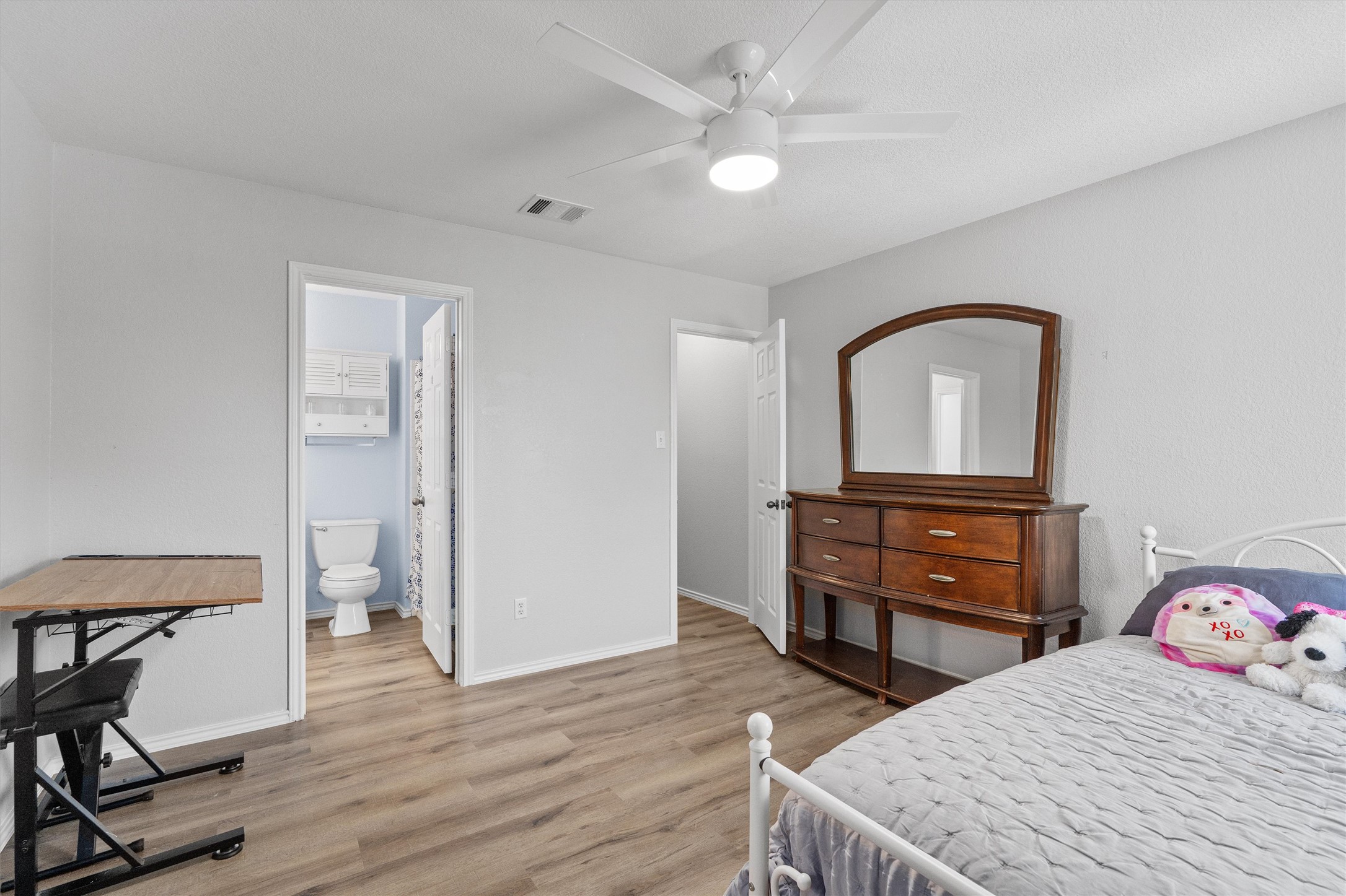 1833 Thompson Trail Round Rock, TX 78664 - Photo 29 of 40 A comfortable bedroom with rich wood flooring features a convenient en-suite bathroom.