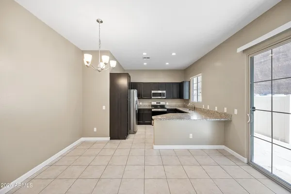 a kitchen with stainless steel appliances a refrigerator and a stove top oven