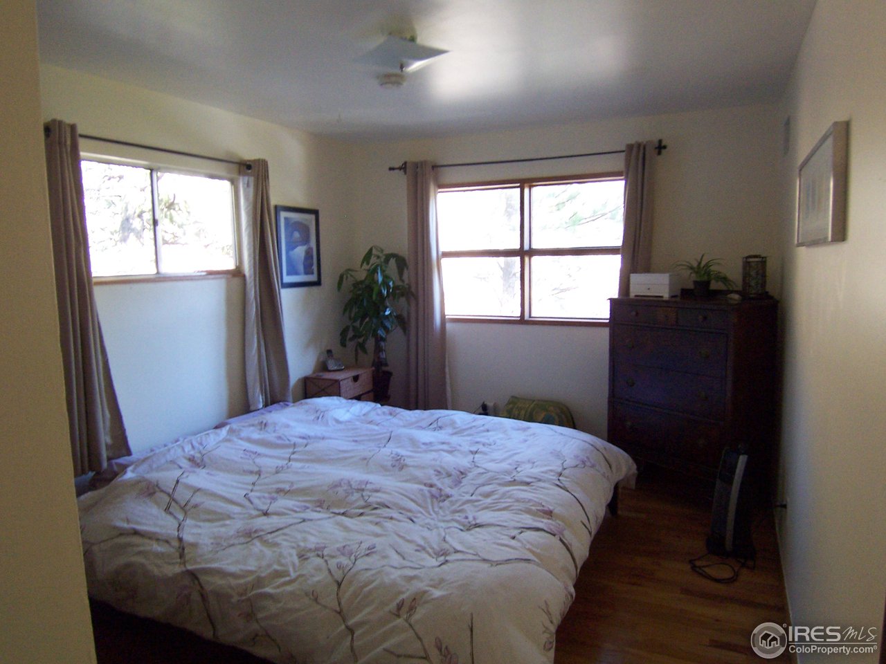 223 Gold Run Road Boulder, CO 80302 - Photo 7 of 18 a bedroom with a bed and wooden floor