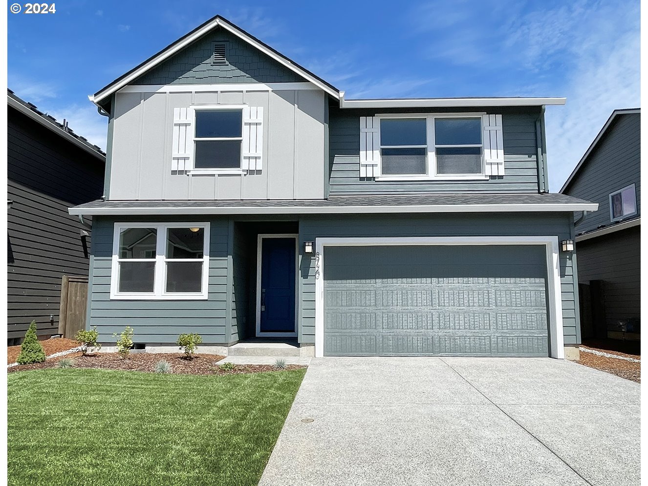 8720 North 3rd Street, Unit 57 Ridgefield, WA 98642 - Photo 1 of 24 a front view of a house with a yard and garage