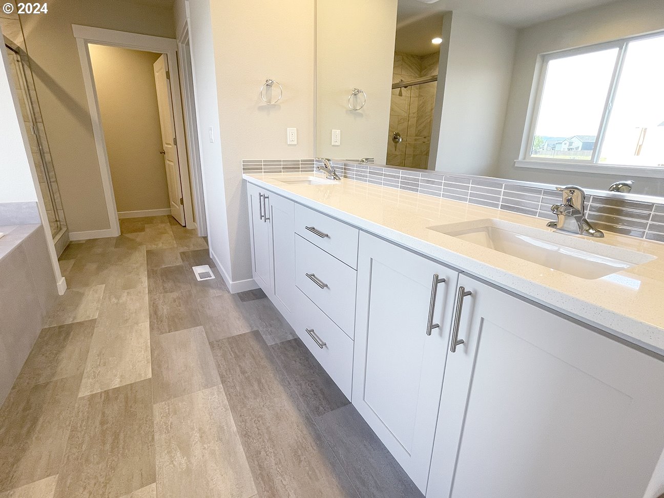 8720 North 3rd Street, Unit 57 Ridgefield, WA 98642 - Photo 13 of 24 a spacious bathroom with a double vanity sink and a mirror
