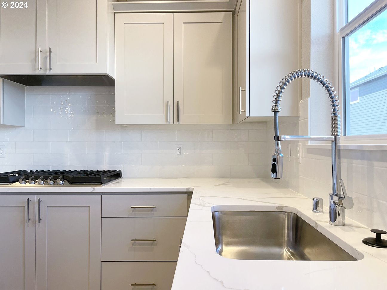 8720 North 3rd Street, Unit 57 Ridgefield, WA 98642 - Photo 5 of 24 a kitchen with white cabinets and a sink