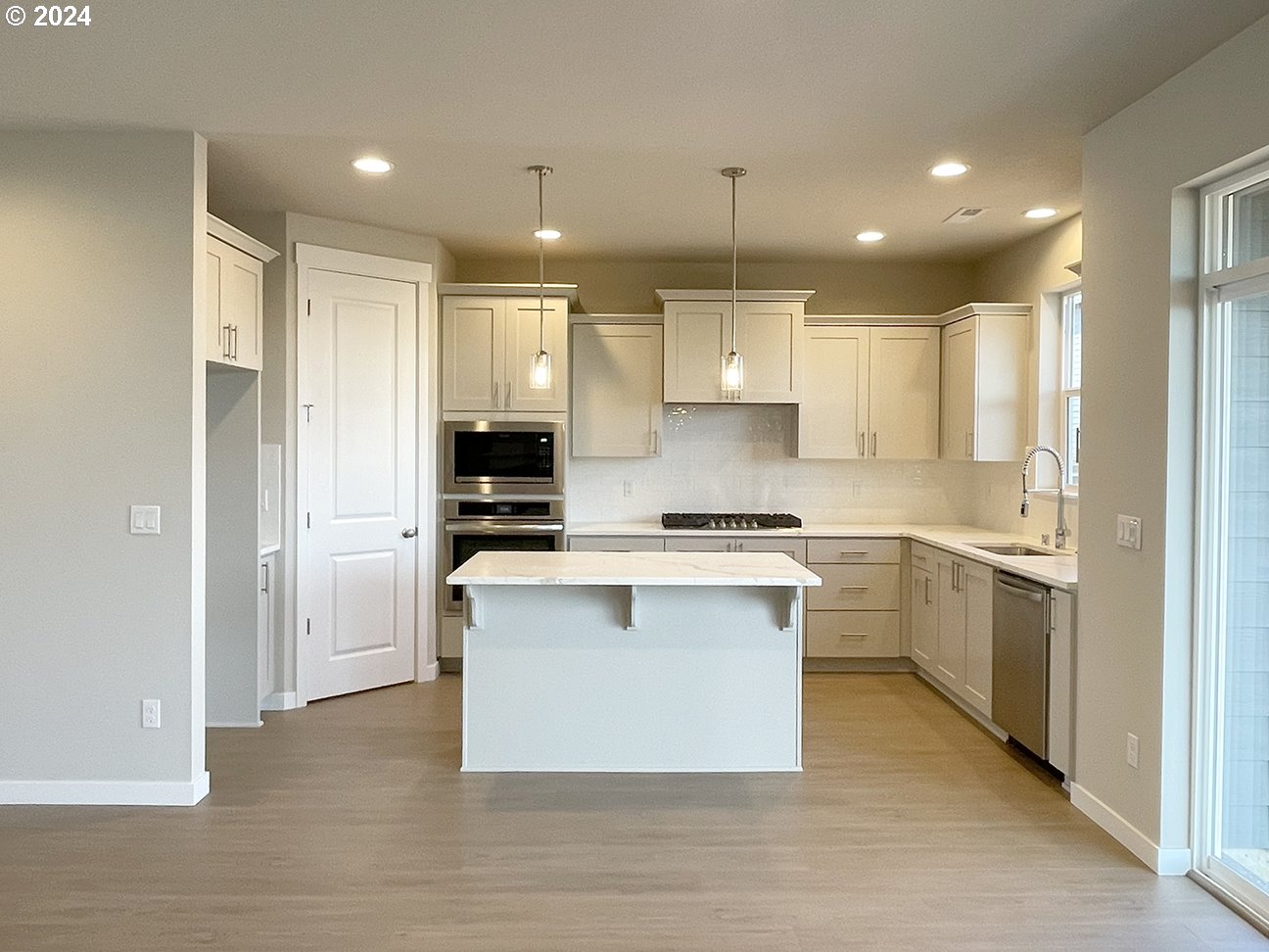 8720 North 3rd Street, Unit 57 Ridgefield, WA 98642 - Photo 6 of 24 a kitchen with a refrigerator and a stove top oven
