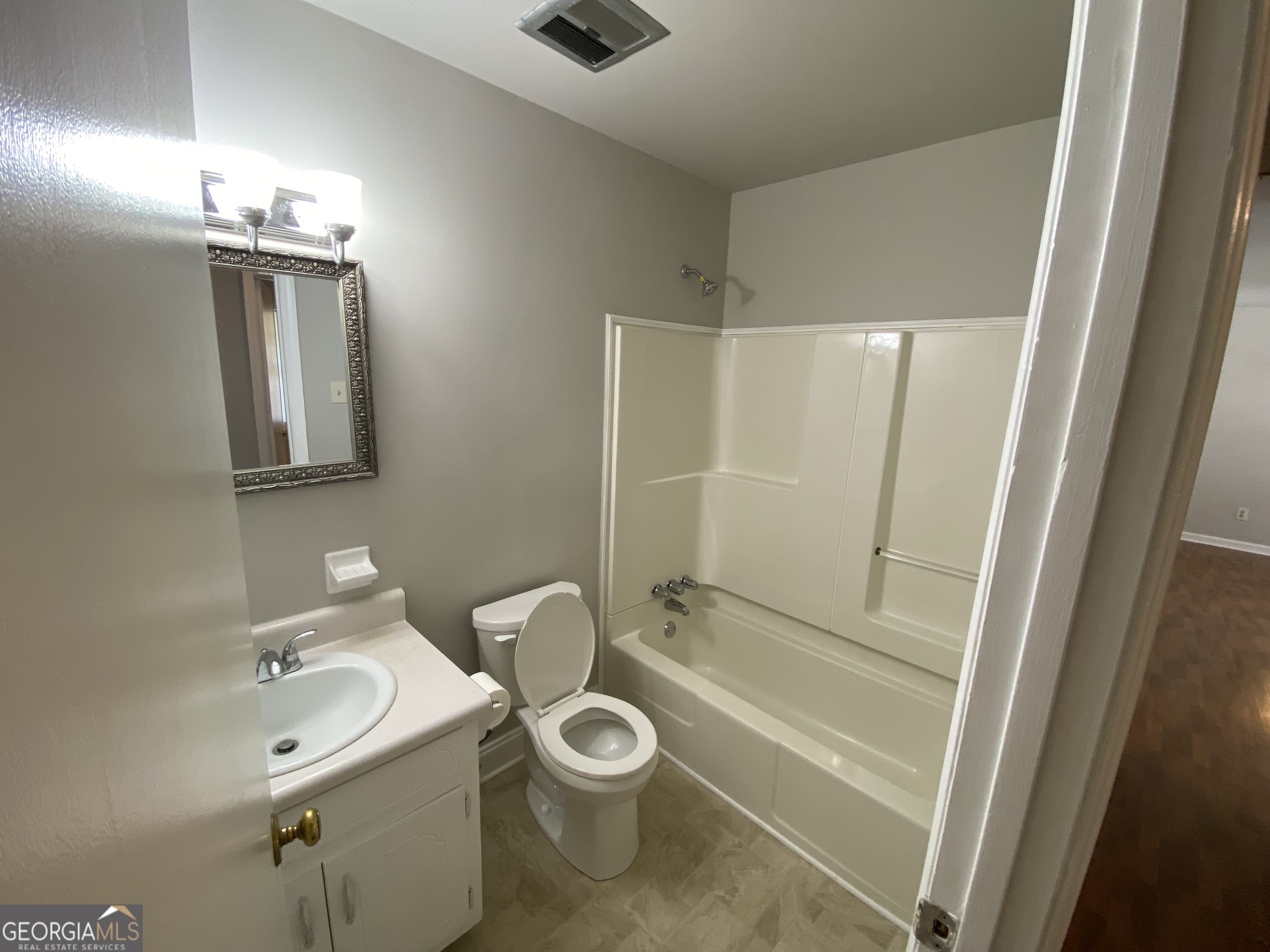 6092 Prestige Valley Road Morrow, GA 30260 - Photo 9 of 11 a bathroom with a toilet a sink a mirror and shower