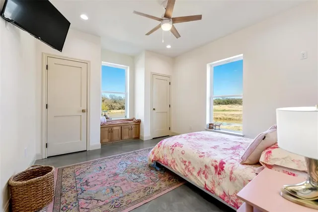 a bedroom with a bed a couch and a window