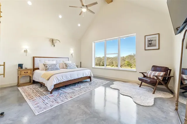 a bedroom with a bed chair and window