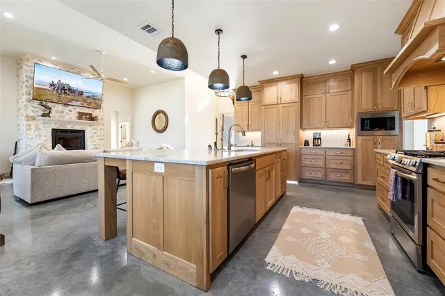 a kitchen with a sink stainless steel appliances and cabinets