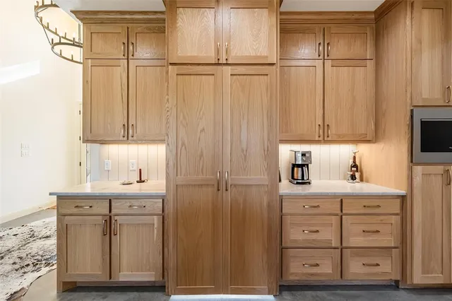 a view of a kitchen with white cabinets