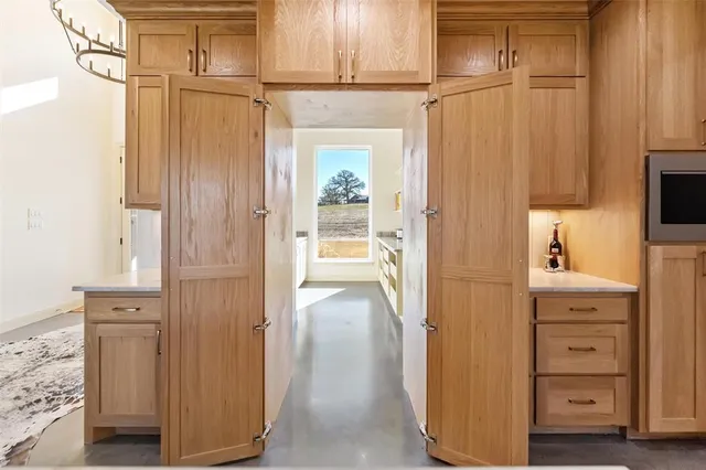 a view of a hallway with closet and cabinet