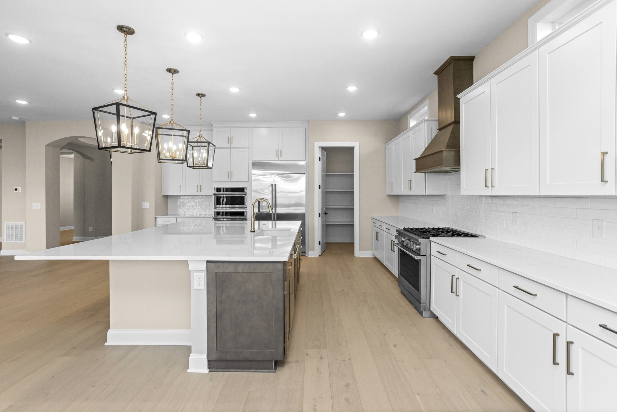 5955 Hunt Vly Drive Spring Hill, TN 37174 - Photo 18 of 59 a large kitchen with stainless steel appliances kitchen island granite countertop a stove a sink a refrigerator and a wooden cabinets