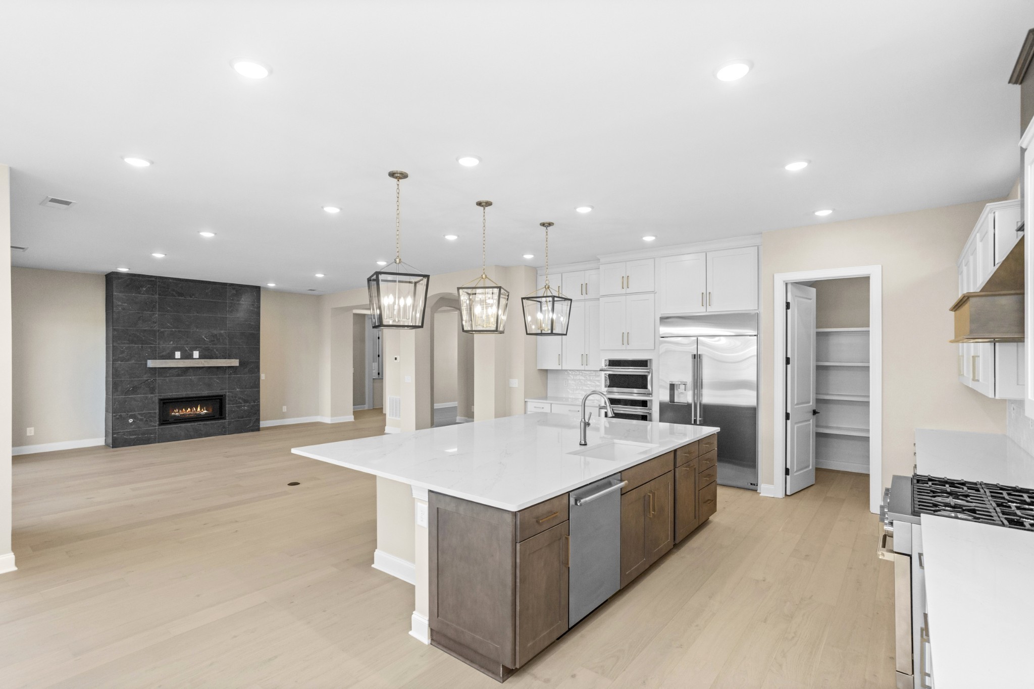 5955 Hunt Vly Drive Spring Hill, TN 37174 - Photo 19 of 59 a large white kitchen with a large kitchen counter top space a sink stainless steel appliances and cabinets