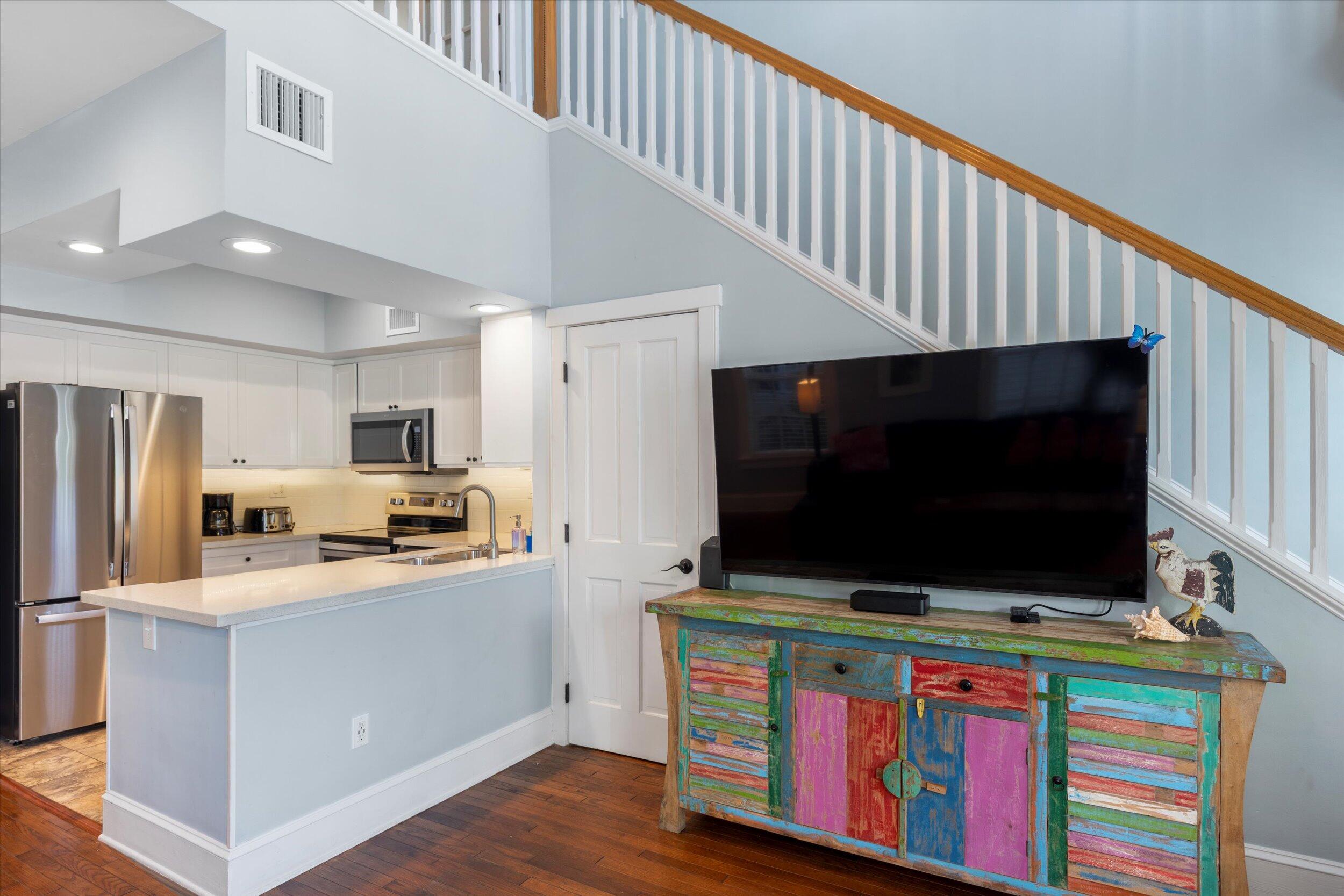 606 Truman Avenue, Unit 7 Key West, FL 33040 - Photo 21 of 49 a living room with furniture and a flat screen tv
