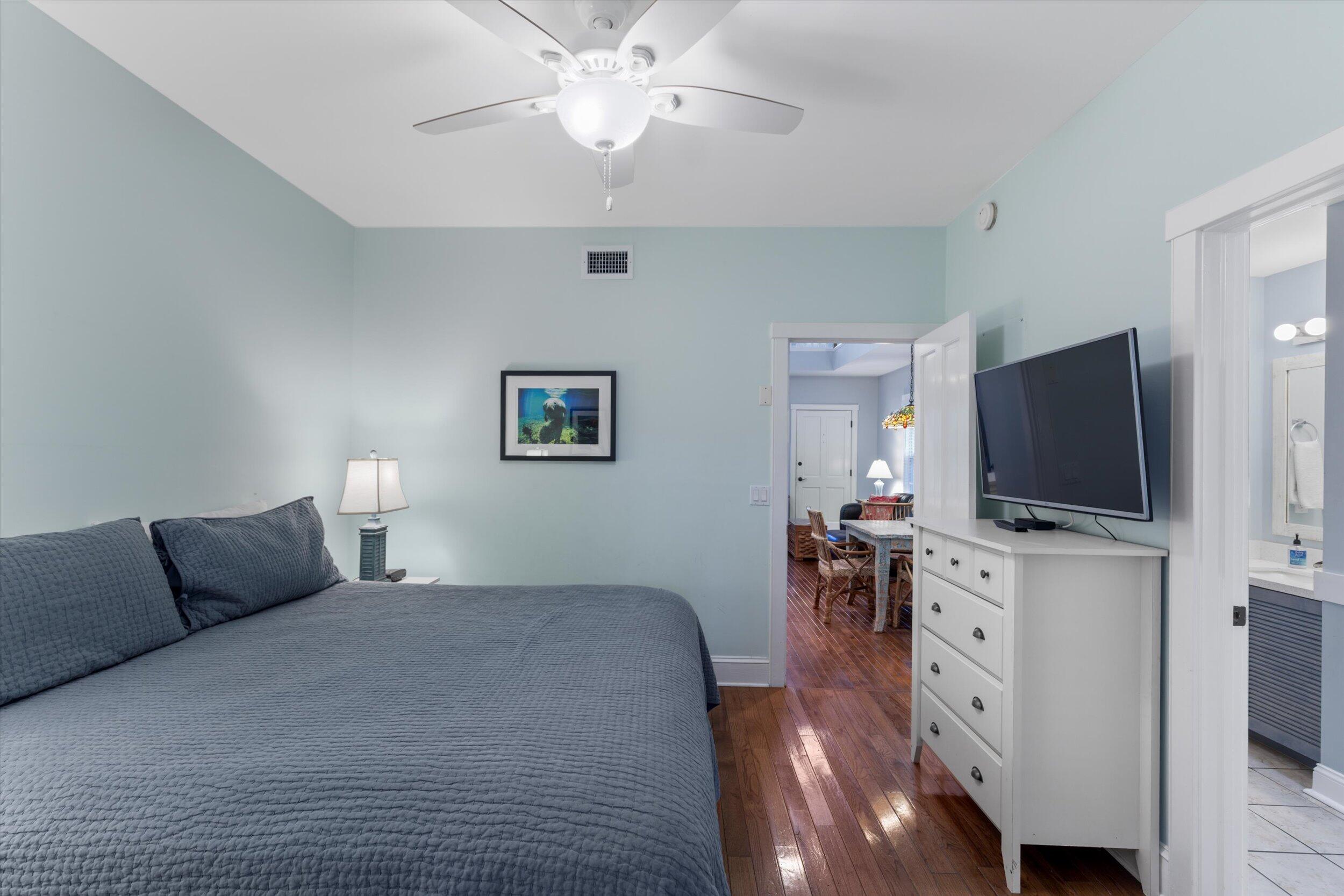 606 Truman Avenue, Unit 7 Key West, FL 33040 - Photo 23 of 49 a bedroom with furniture and a flat screen tv