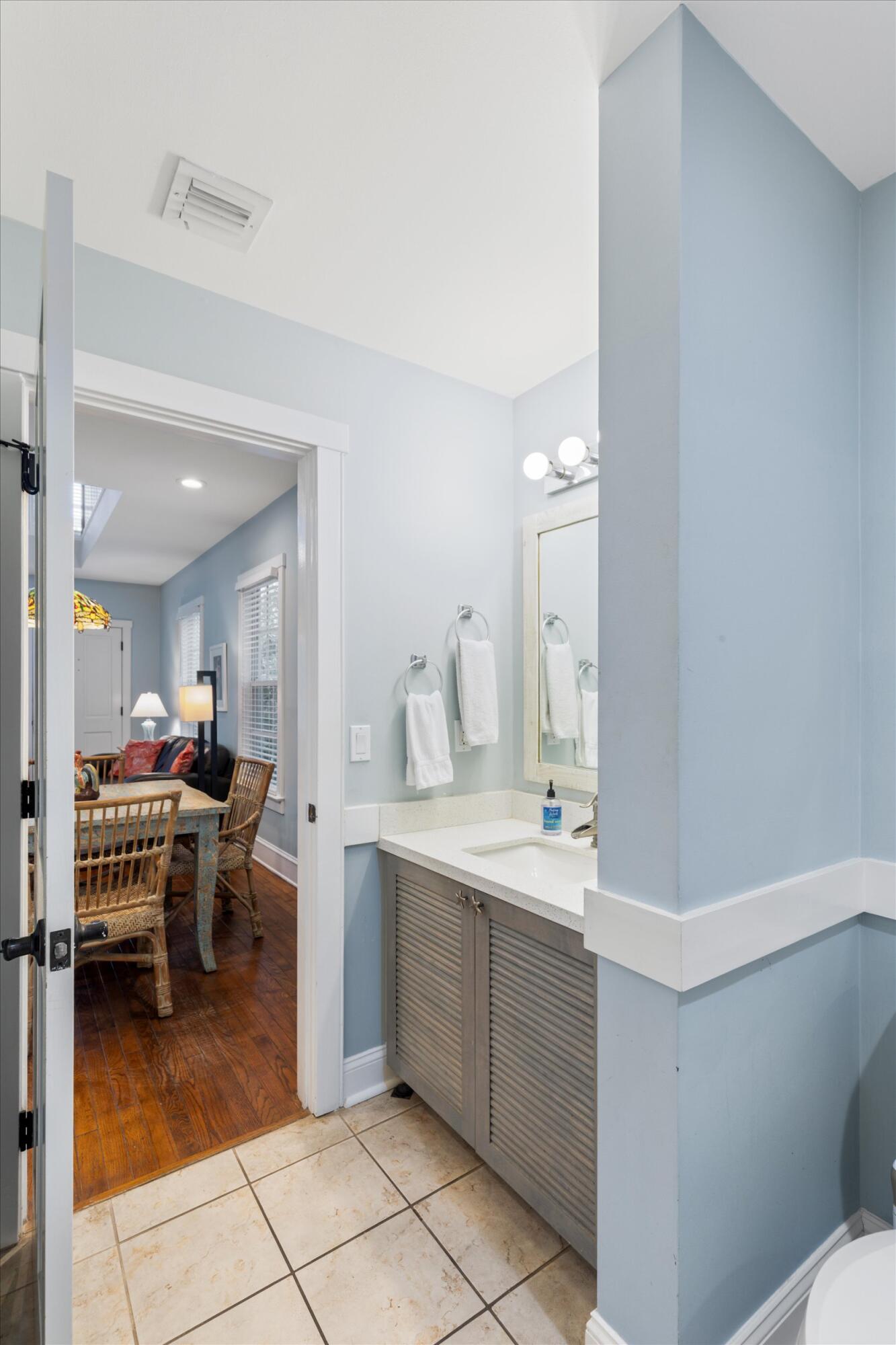 606 Truman Avenue, Unit 7 Key West, FL 33040 - Photo 24 of 49 a kitchen with a sink and chairs