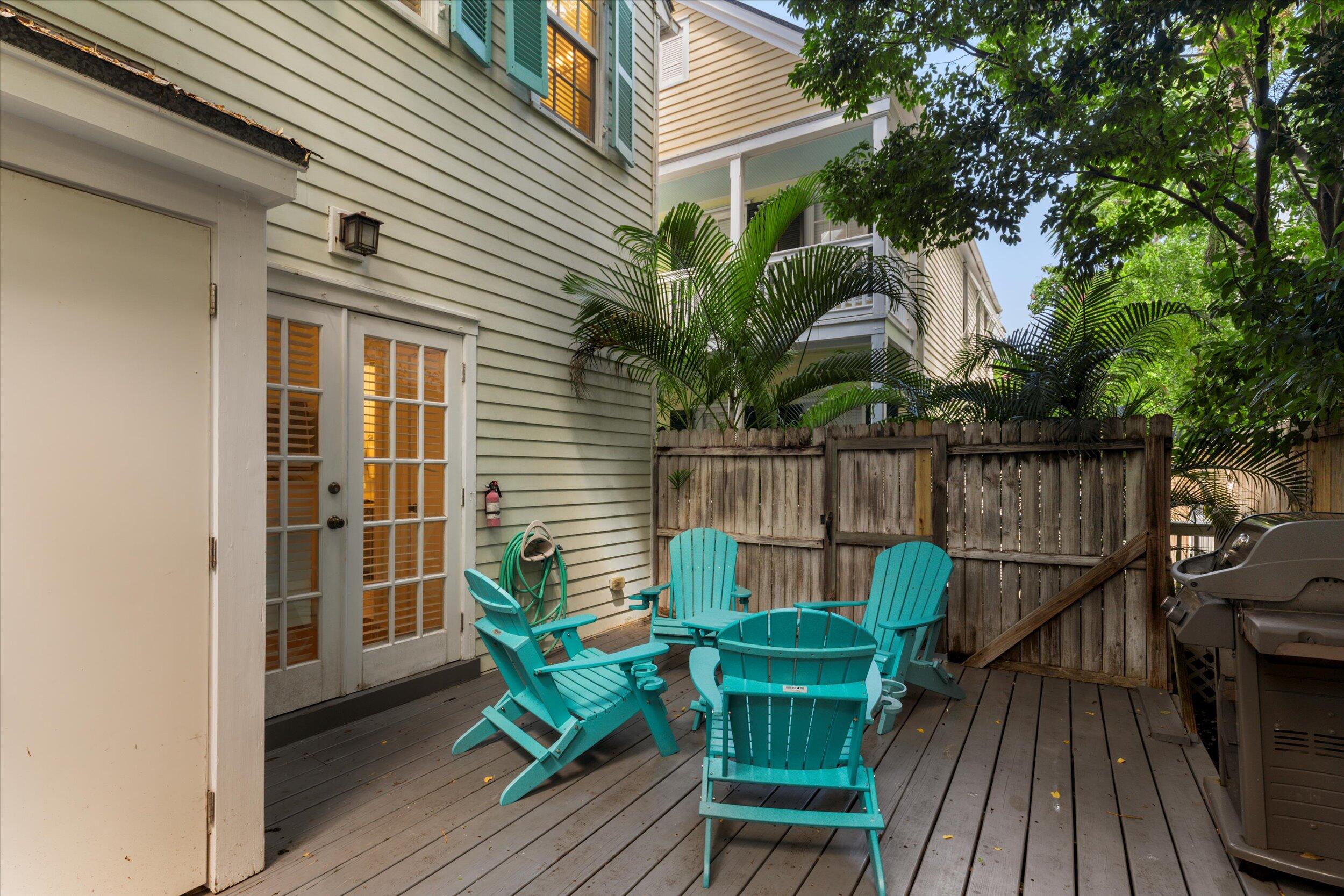 606 Truman Avenue, Unit 7 Key West, FL 33040 - Photo 28 of 49 a view of a chair and table in backyard of the house