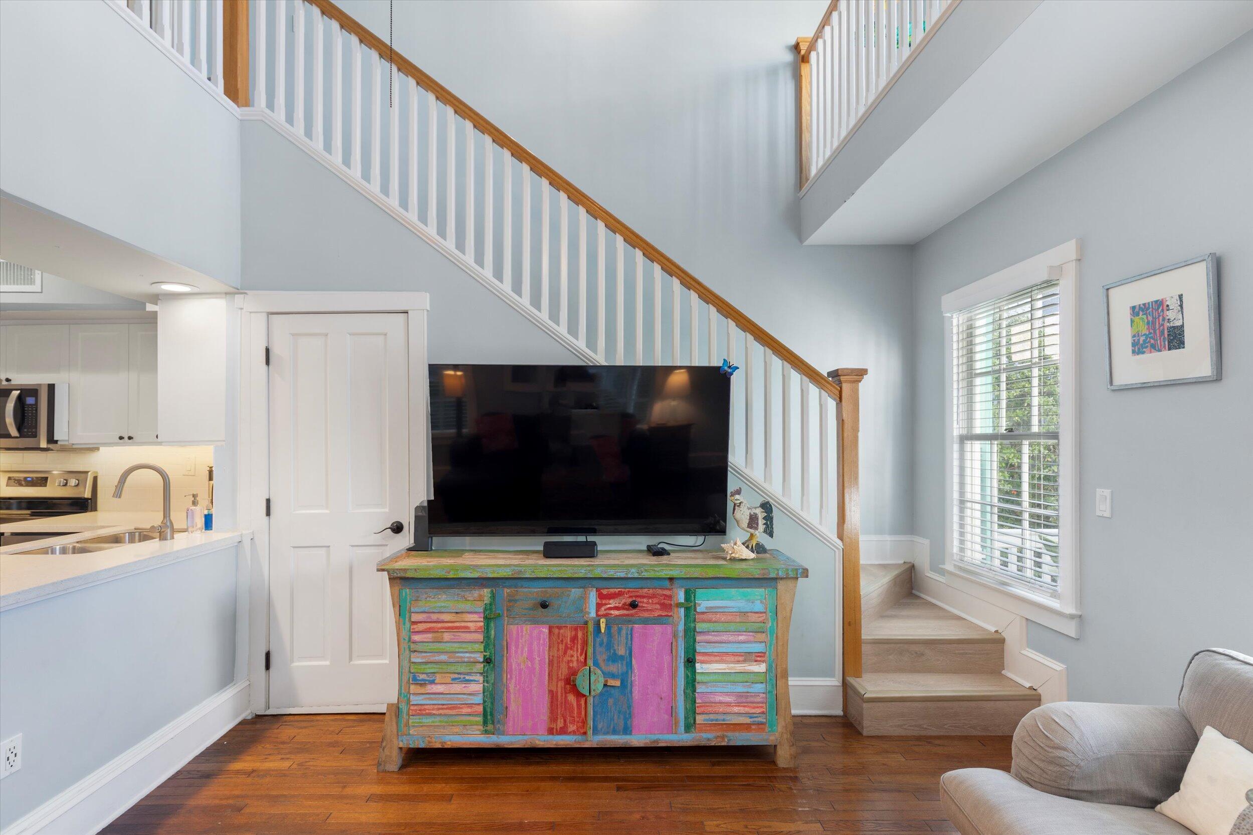 606 Truman Avenue, Unit 7 Key West, FL 33040 - Photo 30 of 49 a living room with furniture and a flat screen tv