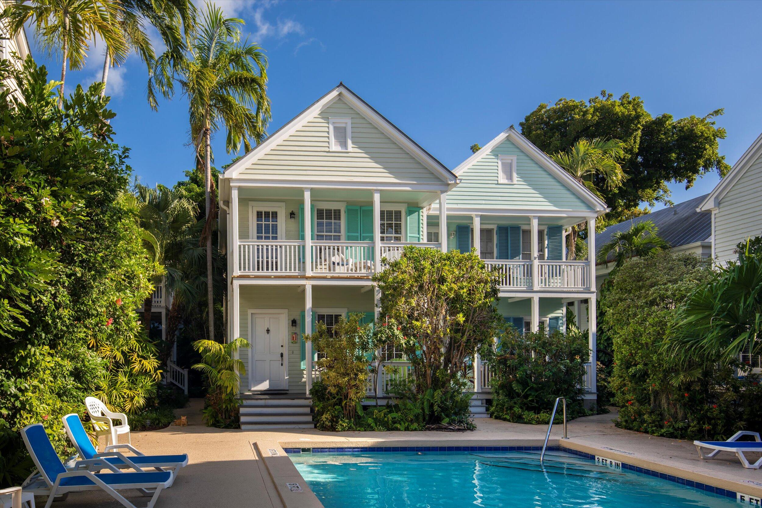 606 Truman Avenue, Unit 7 Key West, FL 33040 - Photo 3 of 49 a front view of a house with garden